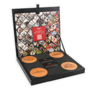 New member box with reveal flap lifted revealing coaster gifts and retail offer cards